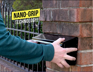 Man attaching mailbox to brick with Alien Tape